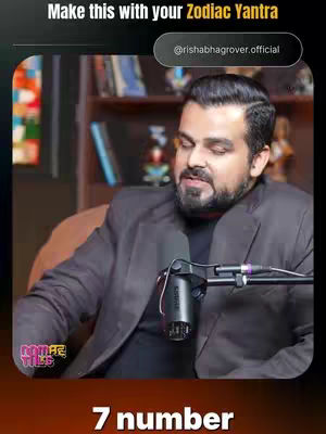 The cover image presents a man with dark hair and facial hair, looking towards the left side of the frame. He is wearing a dark grey blazer over a black shirt, with a microphone in front of him. The background includes blurred bookshelves. Text overlays include the title 'Make this with your Zodiac Yantra' at the top, and '@rishabhgrover.official' within a black oval. At the bottom is the text '7 number' in a bold sans-serif font over a brown gradient.