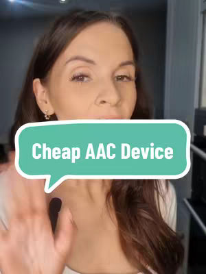 A woman with brown hair looks towards the camera. A speech bubble with the text "Cheap AAC Device" is in front of her face, partially obscuring it. She's wearing a white top, and her right hand is in the foreground, waving.
