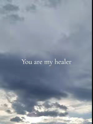 A celestial image featuring a cloudy sky with a gradient of gray and white hues. The text "You are my healer" is superimposed in the center.