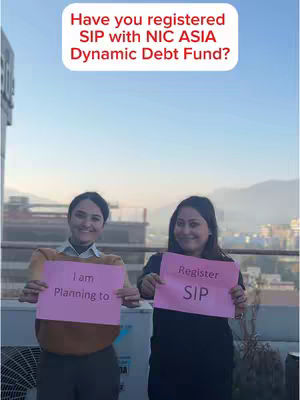 Two women stand outside, holding up pink signs. One sign reads 'I am Planning to,' and the other says 'Register SIP'. Above them, in a white speech bubble, is the text 'Have you registered SIP with NIC ASIA Dynamic Debt Fund?'. The background includes a view of a cityscape under a blue sky.