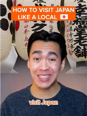 A selfie-style shot featuring a smiling man against the backdrop of Japanese lanterns with Japanese characters. A text overlay reads 'HOW TO VISIT JAPAN LIKE A LOCAL' in a vibrant orange banner, and another text overlay at the bottom says 'visit Japan'.