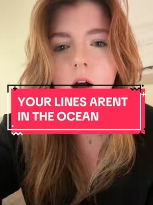 A close-up shot focuses on the face of a woman with long, wavy red hair and a nose ring. She is looking directly at the camera with a partially open mouth in what appears to be an expression of surprise or curiosity. A bright red rectangular text overlay is at the center of the image, with white text.