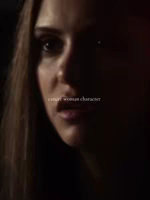 A close-up shot of a woman's face, the frame focuses just above the eyes to her mouth. The background is dark, creating a low-key lighting effect. The text 'cancer woman character' is overlaid near the bottom.