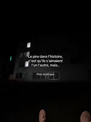 A dark image of a building at night with text overlays. The building has lit windows. The lower portion of the image shows a person's feet. The text asks to complete a sentence about a painful situation.