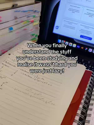 The cover image shows a desk with study materials. A laptop is open, displaying a screen with text. Below the laptop, a notebook with handwritten notes is visible. To the left are stacks of books with colorful sticky notes. The text overlayed on the image is in a white font.