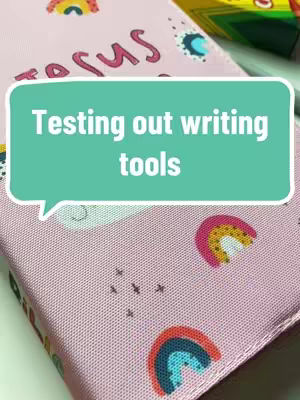 A close-up shot of a pink Bible cover with the word 'jesus' partially visible, a speech bubble containing the text 'Testing out writing tools', and decorative rainbows.