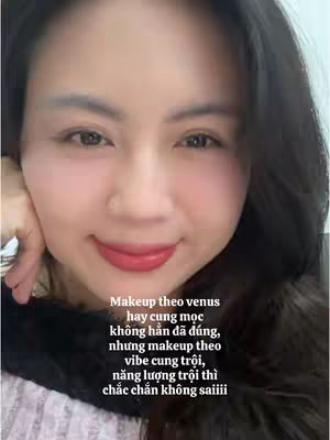 A close-up shot of a woman with fair skin, dark hair, and red lipstick. She's resting her cheek on her hand and looking at the camera. Text overlays are in a soft font, with the background appearing slightly blurred.