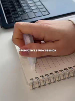 The image shows a hand holding a white correction tape over a lined notebook, correcting a line. A laptop is partially visible in the background. The notebook has a spiral binding. The words 'PRODUCTIVE STUDY SESSION' are overlaid on the image.