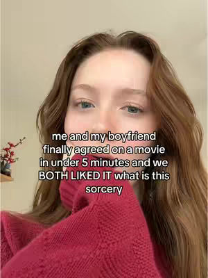 A selfie-style shot with the creator’s face prominently in the frame. She is wearing a red sweater and has light brown hair. Text is overlaid on the image.