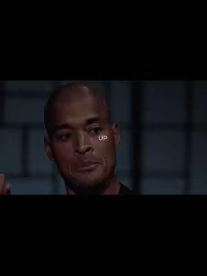 The cover image features a close-up of a bald man's face, positioned in front of a dimly lit, possibly indoor background. The man looks towards the left, his expression suggesting contemplation or a slight frown. The word 'UP' is overlaid near his right eye.