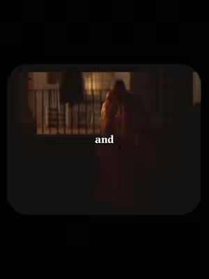 The cover image is a still from a scene, framed within a rounded-rectangle border. The scene appears to be an interior space, possibly a room with a view of the outside. The lighting is dim, and the color palette is dominated by dark tones with warm highlights that suggests the use of a filter. The image is focused on a central figure with text overlayed.