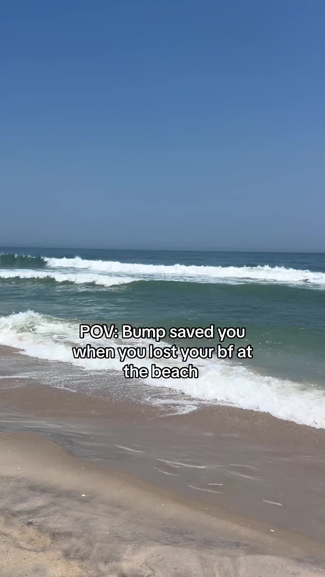 The image captures a scenic beachfront view under a clear blue sky. The ocean stretches across the frame, with waves breaking near the shore. The beach itself is visible in the foreground. Overlayed text at the bottom provides context.