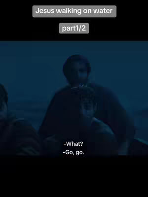 The image shows a scene from a film or TV show with three figures in what appears to be a boat, on water. Two figures are more clearly visible, while the third is partially obscured on the left side. The lighting is dim and creates a blueish hue over all the imagery, indicating the sea or environment. Text overlays present on the upper side, indicating "Jesus walking on water" and "part 1/2", with dialogues at the bottom of the shot. The composition is cinematic, with a focus on storytelling through a dramatic atmosphere and expression.