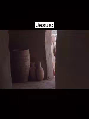 The image captures a dimly lit, stone-walled interior with arched doorways. A figure is partially visible in the doorway, dressed in white. Various items, including large clay pots and a wooden barrel, are placed within the space, evoking an ancient setting.