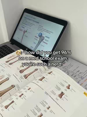 A laptop displaying a medical diagram sits open on a table with a textbook featuring detailed anatomical images. The hook overlay features a text asking 'How did you get 96% on a med school exam, you're such a nerd!'