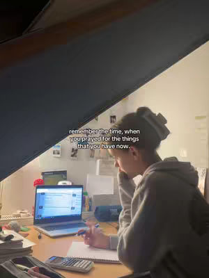 The image shows a young person studying at a desk, with a laptop open and a notebook in front of them. The person is side-profile, with the main focus on the person and a hook overlayed on the image.