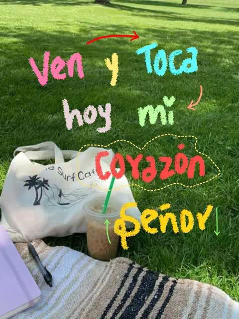 A serene outdoor scene featuring a green grassy area with handwritten text overlayed. A white tote bag with a palm tree design, a clear plastic cup with a straw containing a beverage, a journal, and pen are placed on top of a patterned blanket on the grass. Text in different colors, suggesting a gospel message, is scattered across the image.