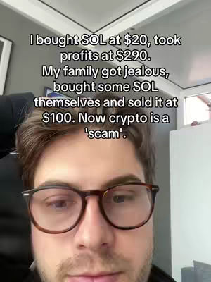 A close-up shot of a man with glasses, looking down towards the camera. Text is overlaid on the image with a story about crypto.