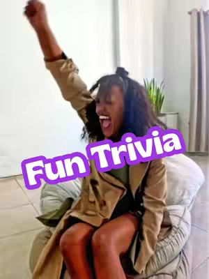 A woman with dark hair is sitting in a chair, arms raised in the air. In the foreground, a text overlay reads "Fun Trivia".