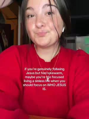 A young woman with long dark hair and olive skin looks directly at the camera with a gentle smile. She's wearing a red long-sleeve shirt with a gold necklace, and a white earbud is visible in her ear. Text is overlaid on the bottom of the image, which provides the message.