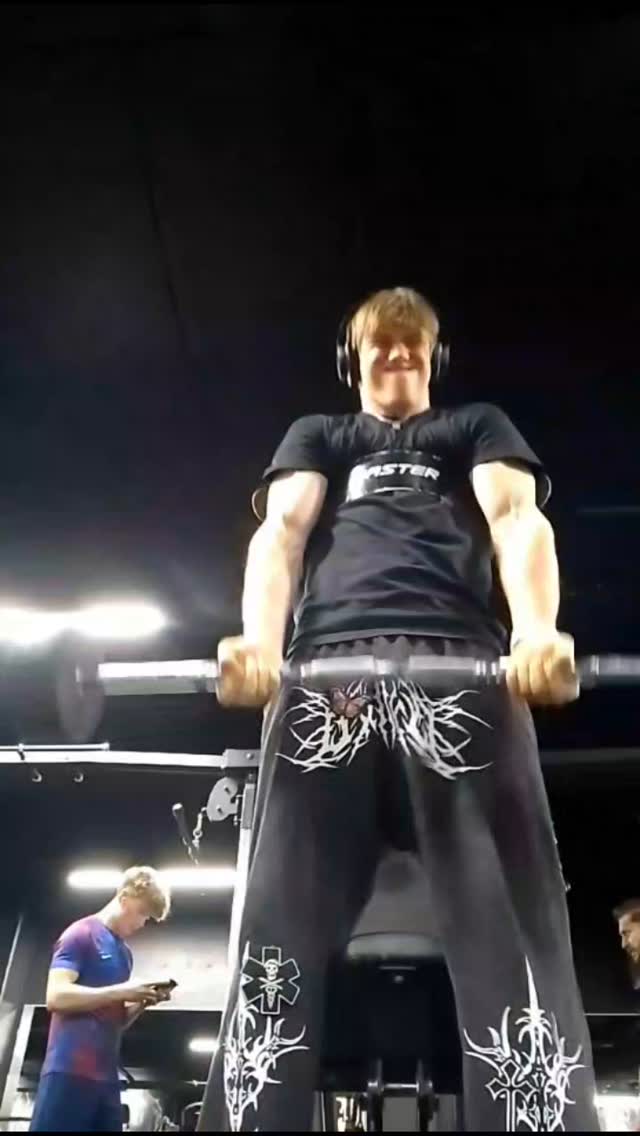 A cover image from a gym demonstrates a body builder with a barbell and others, and a secondary subject using a smartphone.