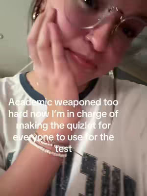 A selfie-style image featuring a young woman with glasses, her hand touching her cheek. Overlayed text expresses a relatable academic experience.