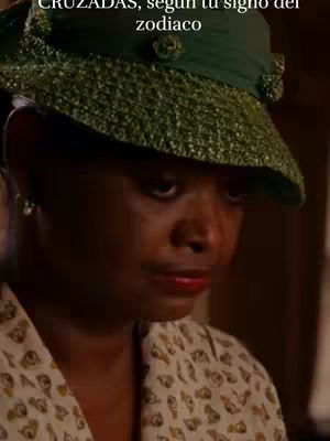 The cover image features a close-up of a Black woman wearing a green hat. Her facial expression appears somber, with a hint of sadness in her eyes. She wears a patterned shirt, and the lighting suggests an indoor setting.