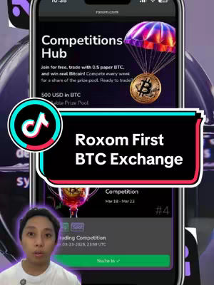 The cover image shows a man in front of a smartphone screen. The screen displays an app interface with the text "Competitions Hub" and a golden Bitcoin icon descending below a parachute. Overlaid on the screen is a text box that reads, "Roxom First BTC Exchange." The man in the foreground is looking towards the camera.