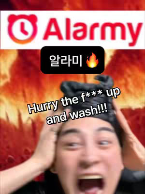 The cover image features a person with a wide-open mouth and hands on their head. In the top center, there's a logo reading "Alarmy" with a clock icon and associated text in red. Above the person's head are texts that read "Hurry the f*** up and wash!!!". There is a background that appears to be a fiery or heated texture. The person in the shot has a somewhat shocked expression.