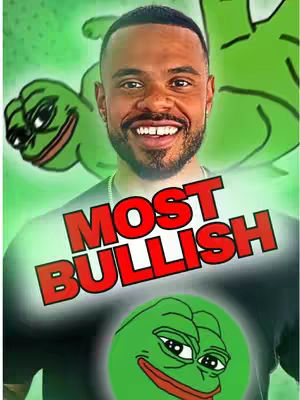 A man with a beard and a wide smile is centered, wearing a dark shirt with the words 'MOST BULLISH' in large red text. Behind him, a green cartoon frog is slightly visible on the left and above his head. There's also a smaller frog image on the shirt. The background is a gradient of green.