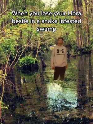 A man in a grey hoodie stands in a swamp. The water is murky, and the background features dense trees and foliage. Text overlays the image, adding context to the scene.