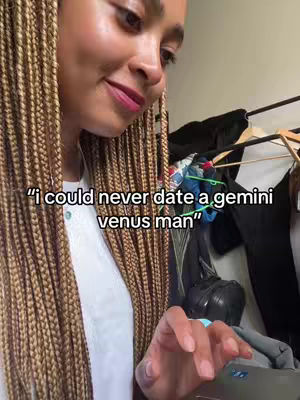 The cover image shows a woman, seen from the chest up, with long braided blonde hair, looking down and to her left. She appears to be inside, likely in a room, with clothing hanging in the background. Text overlayed above the woman says, "i could never date a gemini venus man".