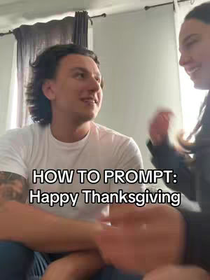 A man in a white t-shirt is the central figure, looking slightly off-camera as though talking to another person. The cover also features a woman on the right side. The background is a typical indoor scene with a curtain. The text overlay reads 'HOW TO PROMPT: Happy Thanksgiving'.