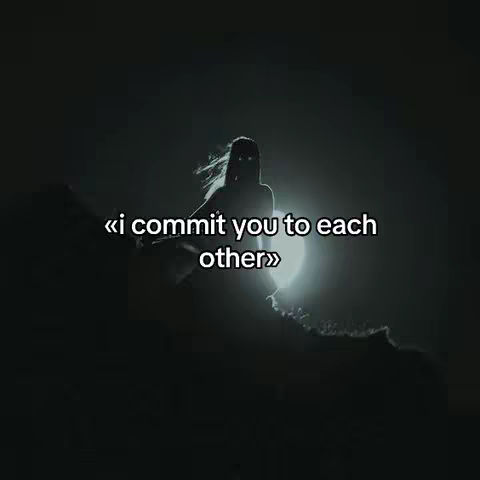 A silhouetted figure of a woman standing on a rocky surface against a dark, atmospheric background. The silhouette is set against a bright, almost full moon, creating a stark contrast. The figure appears to be gazing out, or looking upwards.