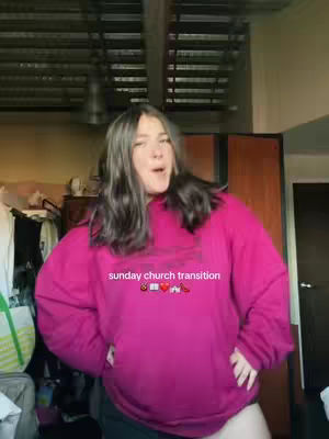 A woman in a pink sweatshirt stands with her hands on her hips in a room with a window and wardrobe in the background. Text overlayed on the image says 'sunday church transition'.