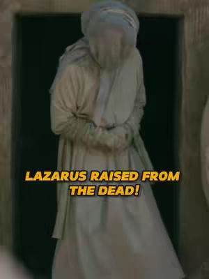 The cover image features a figure wrapped in white cloth, possibly representing a biblical figure or someone emerging from a tomb. The figure stands inside a dark doorway. A yellow text overlay reads 'LAZARUS RAISED FROM THE DEAD!'