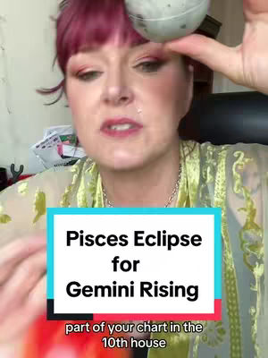 A woman with bright red hair, wearing a light green patterned top, is the focus of this vertical video cover image. She has visible makeup, including eye shadow. A blue and white rectangular graphic at the bottom of the screen has text laid over a red banner.