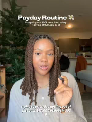 The cover image features a woman of color speaking directly to the viewer with a hand gesture. Text overlays, in a serif font, at the center top includes "Payday Routine" then a subtitle related to finances. A secondary overlay at the bottom discusses debt reduction. The background is partially blurred, showing a home interior with a Christmas tree.