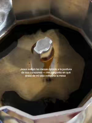 An overhead shot inside of what appears to be a coffee maker. Dark liquid fills most of the frame, with a metal piece in the center.