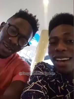 The cover image is a selfie-style shot featuring two young men, captured from the chest up. The man on the left is seen from a slightly lower angle, wearing glasses and a short haircut. He is wearing a red t-shirt. The individual on the right has a shorter haircut and is wearing a patterned button-down shirt. The background is blurred, suggesting an indoor environment. There is text overlaid on the bottom to identify the channel.