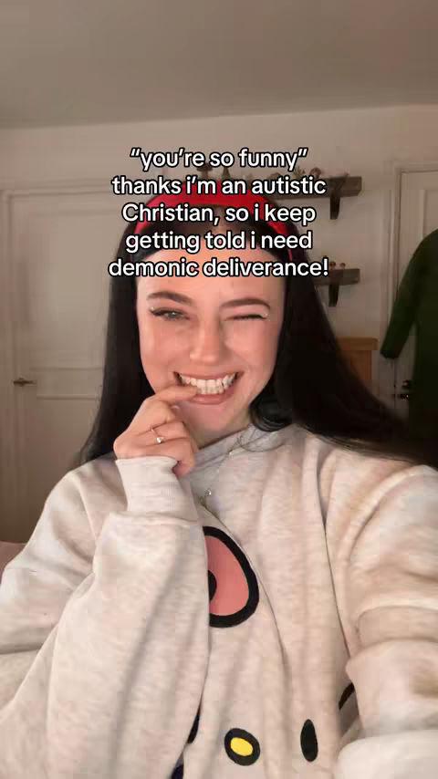 A young woman with dark hair and fair skin is smiling and winking at the camera. She is wearing a light-colored hoodie. Text overlays are present at the top, in a bold sans-serif font.