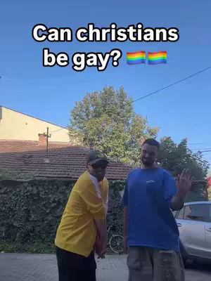 Two men standing outside, one in a yellow shirt, one in a blue shirt, with text at the top asking "Can christians be gay?" with a rainbow flag.