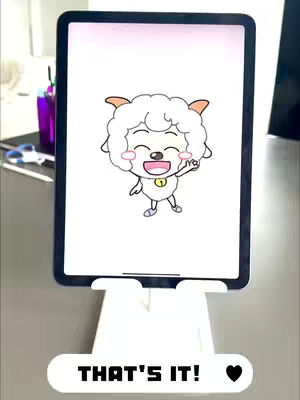 An iPad displaying a cartoon sheep character on its screen. The iPad is placed on a white stand, positioned against a neutral background. The cartoon features a white furry sheep with a smiling face, waving its right hand. Below the iPad, on the stand, is the text overlay.