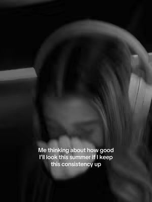 A grayscale photo shows a person with long hair, possibly a woman, with one hand covering their mouth and peering down. Text overlayed on the image reads 'Me thinking about how good I'll look this summer if I keep this consistency up'. The overall effect is somewhat blurred, with a focus on the emotion of the moment.