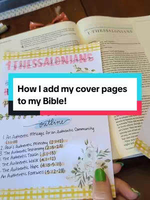 The image shows an open bible with a colorful overlay sheet placed on top, secured with washi tape. The overlay sheet has the title of 1 Thessalonians in pink cursive, and beneath is the phrase 'How I add my cover pages to my Bible!' in a teal speech bubble. A handwritten outline of the chapters is on another page in the bible. The scene has a soft, well-lit ambiance.