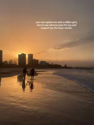 A stunning beach scene at sunset. The sky is a gradient of orange and yellow, reflecting on the wet sand. Two figures are walking towards the water. Text is overlaid in the upper right corner.