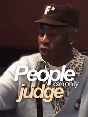 The cover image features Tyler, the Creator, speaking into a microphone. Overlayed on top is the text "People judge", with "People" in a clean white font and "judge" in a contrasting orange hue, positioned centrally. Tyler wears a brown cap with an "F*" logo, a white sweater with a leopard print collar, and a silver earring. The background is a dark, undefined color.