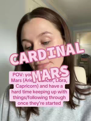 A woman is framed from the chest up, facing the camera with a neutral expression. Her dark brown hair is parted to the side and she is wearing a light grey top. Overlaid on the image are two text boxes. The top text box reads "CARDINAL" in a bubble letter style with a pink outline, slightly curved and placed horizontally. The bottom pink text box, in a similar style, reads "POV: you Mars (Aries, Cancer, Libra, Capricorn) and have a hard time keeping up with things/following through once they're started".