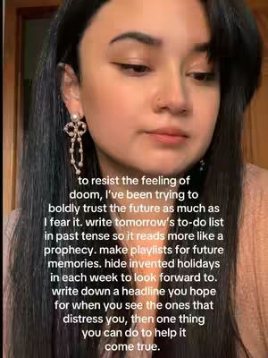 A medium shot features a woman with dark hair and light skin, looking slightly down and to the right with a thoughtful expression. She has brown eyes and is wearing a sparkling earring on her left ear. The background is blurred, with a warm, reddish-brown tone. Overlaid on the image is a block of white text, arranged in multiple lines, offering advice and encouragement.