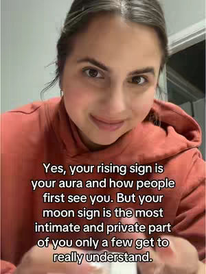 A woman with brown hair and eyes is centered in the frame, wearing a salmon-colored hooded sweatshirt. The image is captured at eye level and fills most of the frame, focusing on her face. Text overlayed on the image gives context. The lighting appears to be indirect, giving the image a soft feel.